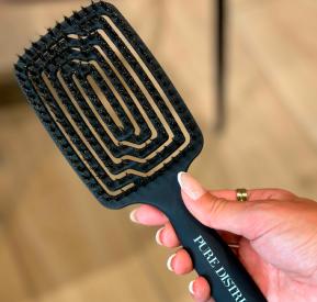 Black hairbrush with boar bristles.